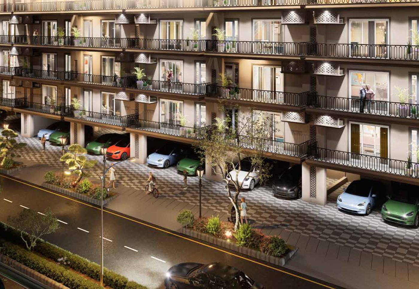 Spiti Floors facade lit at night with covered stilt parking below